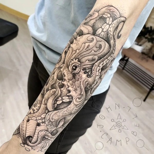 Realistic Octopus forearm black and grey fine line tattoo. Book a custom tattoo with John at Sacred Mandala Studio - Durham, NC.